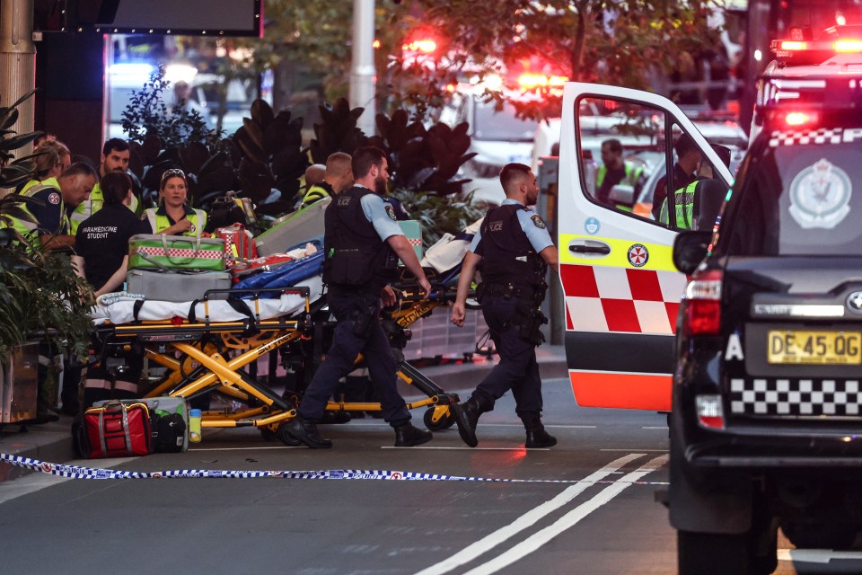 Police and paramedics work outside the Westfield Bondi Junction shopping mall where six were killed