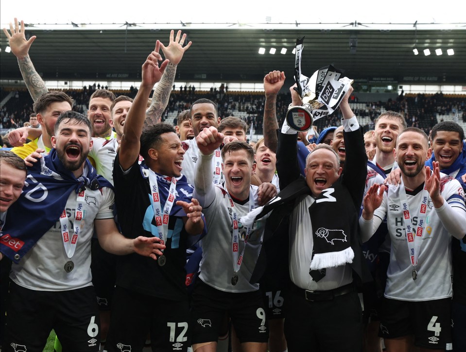 Derby owner David Clowes savours the moment with the second-placed trophy