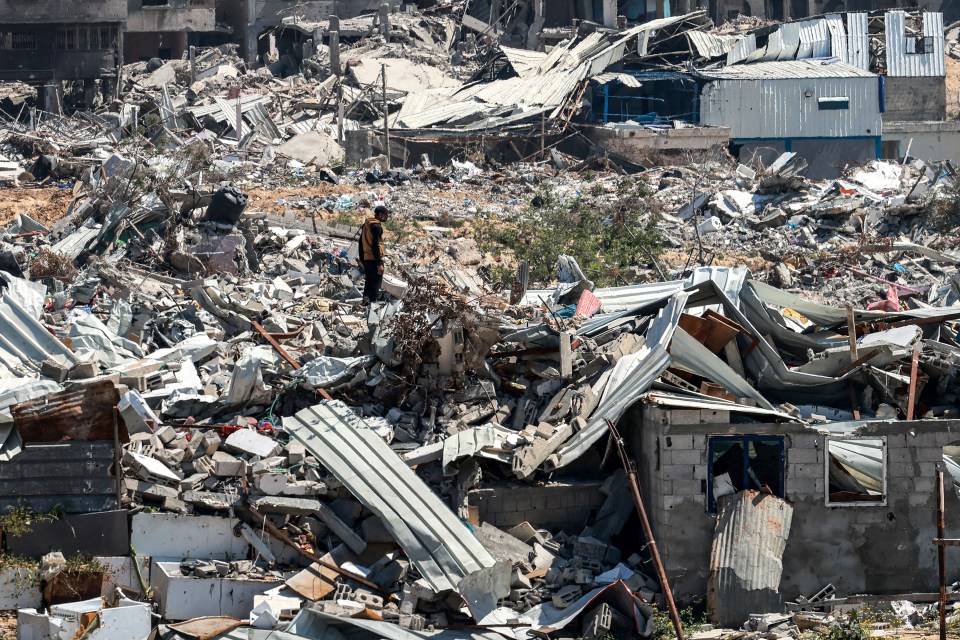 A man stands in the midst of devastation caused by months of Israeli bombardment in Khan Younis