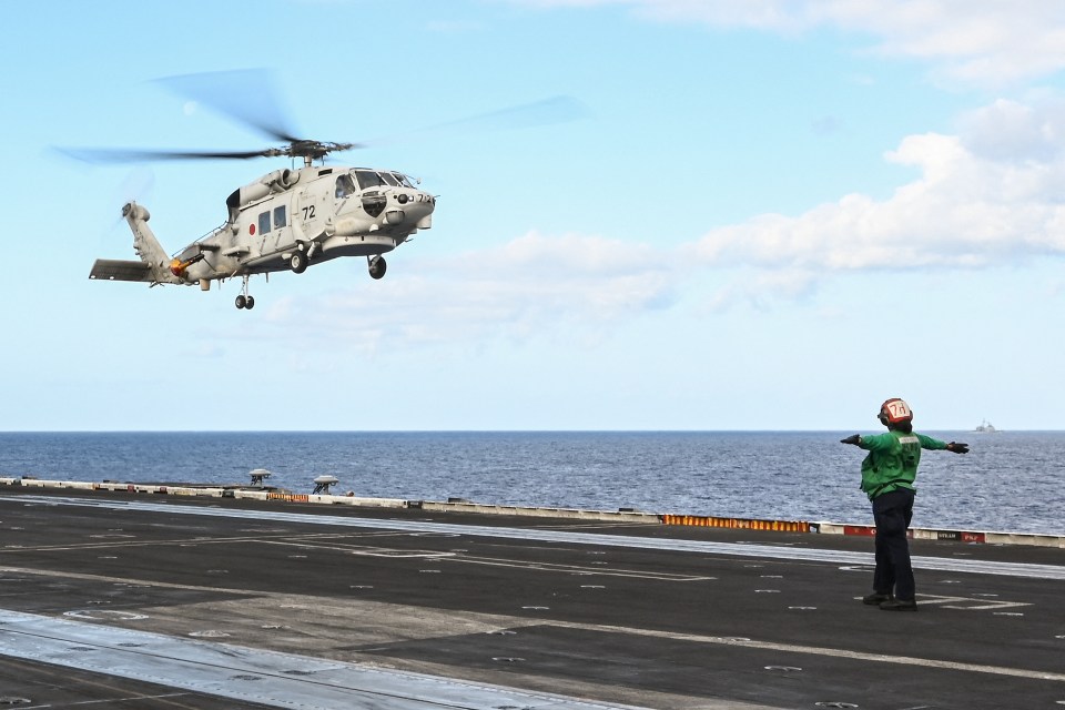 A SH-60K Japan Maritime Self-Defense Force helicopter - also called a Seahawk - landing on an aircraft carrier (file picture)