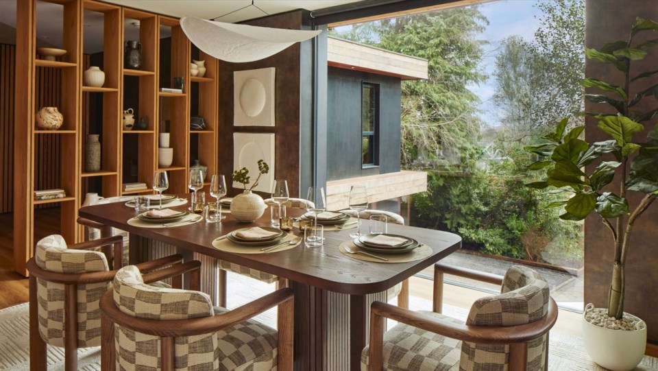 a dining room table with plates and glasses on it