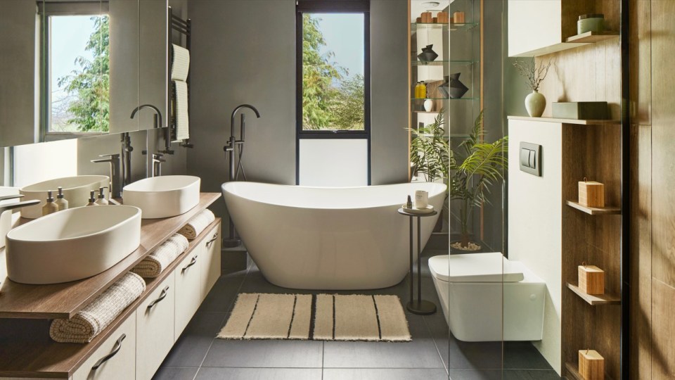 a bathroom with two sinks a tub and a toilet