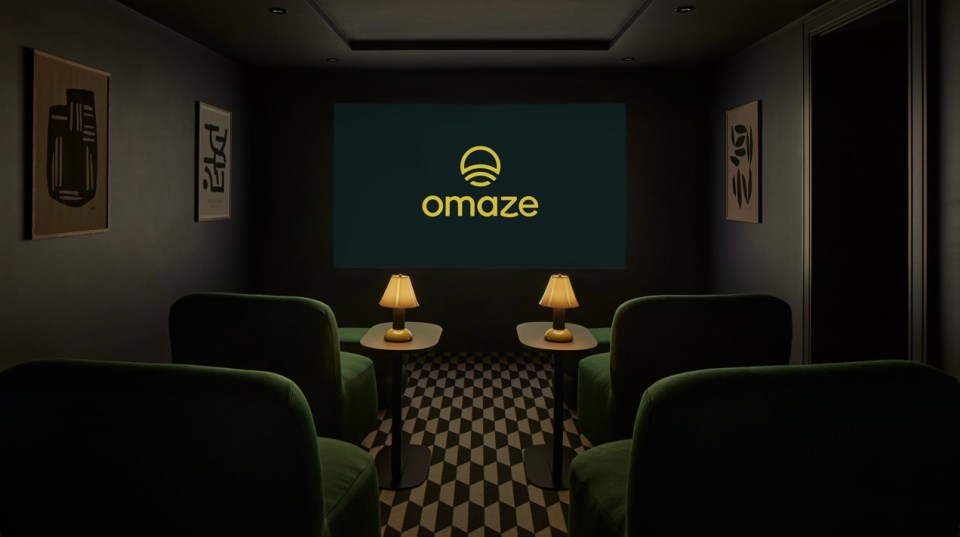 a dark room with a screen that says omaze on it