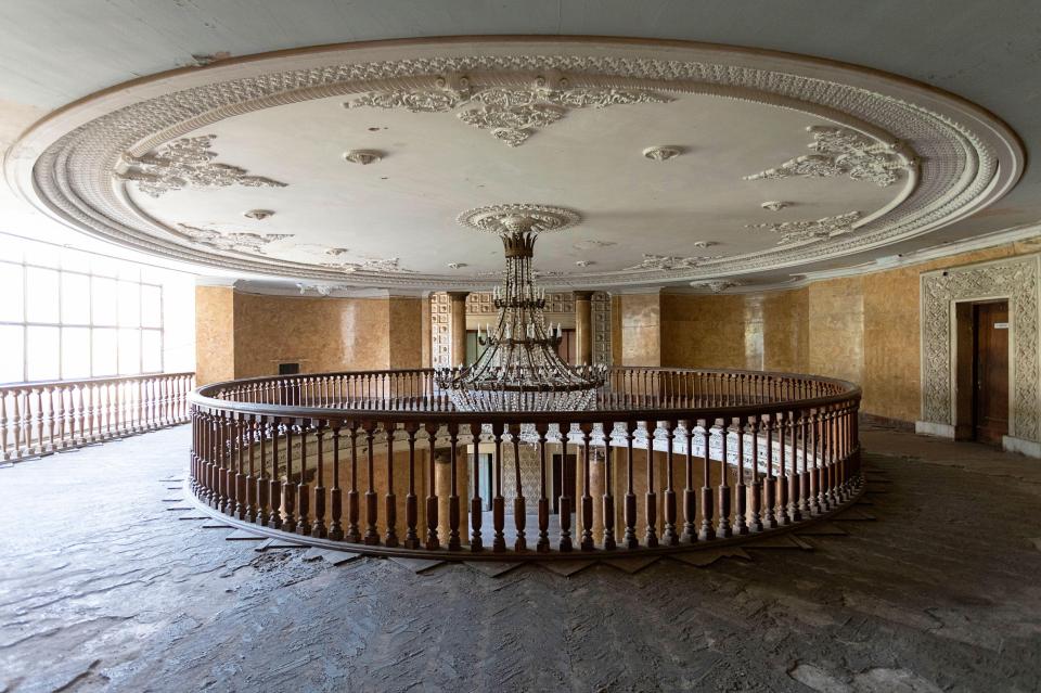 The extravagant chandelier makes a haunting contrast with the derelict once-wooden floors