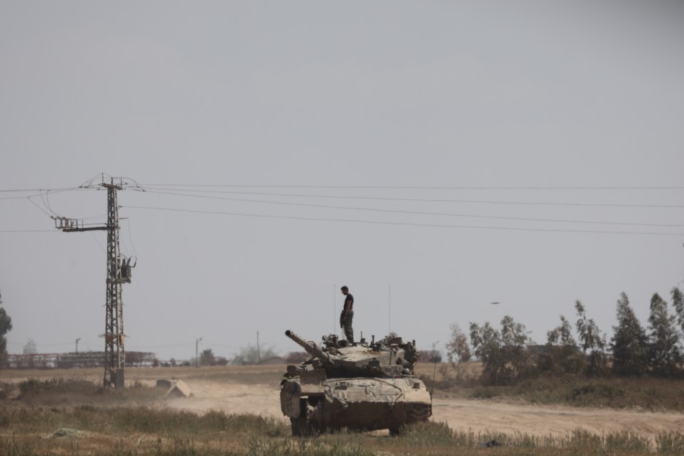 An Israeli soldier on a tank near the border to the Gaza Strip