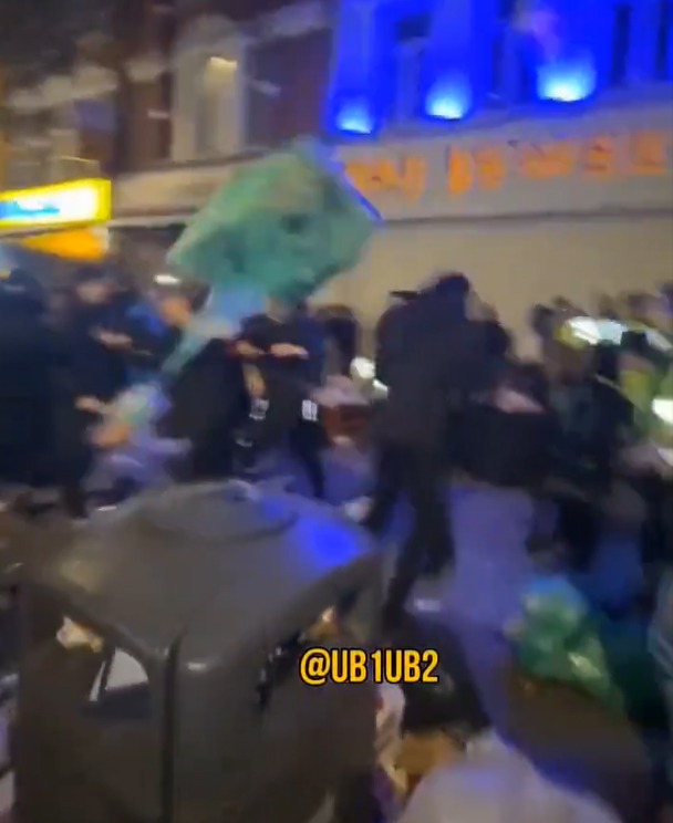 Police are pelted with rubbish in the video