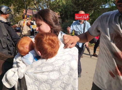 Kfir’s mum, Shiri Silberman Bibas, carries him and his brother, Ariel in previously released footage