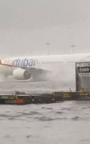 Planes are seen sending up sprays of water at Dubai International Airport