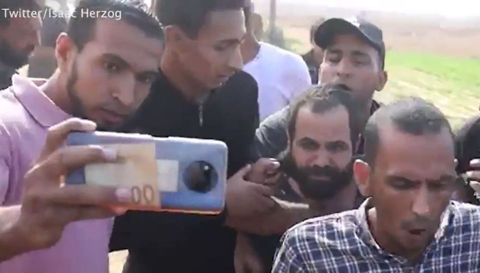 The shocking video then showed members of the mob attempting to take selfies with the helpless dad