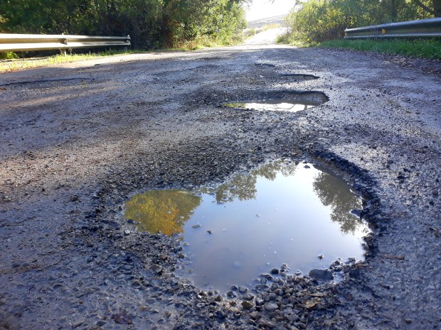 a puddle of water in the middle of a road