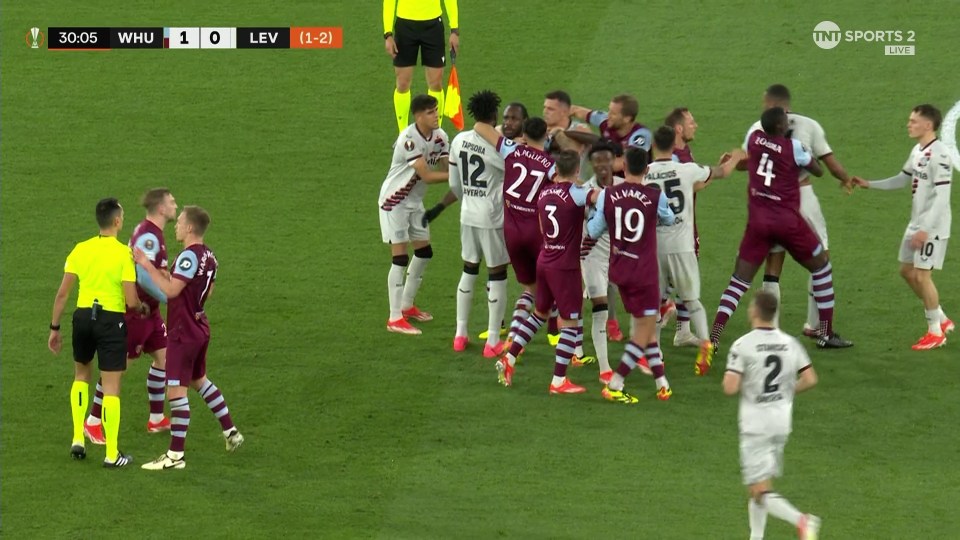 Just as the ref restored order the players started a huge scuffle on the pitch