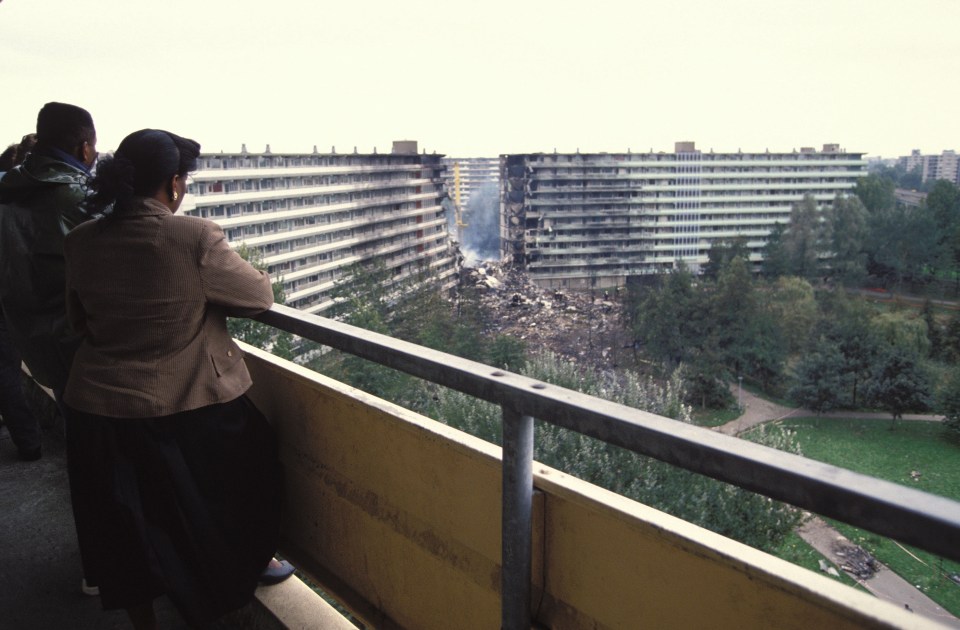 People watch the site of the devastating crash which killed some 200 people