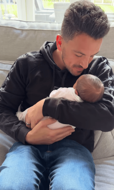 Peter Andre cradles his newborn daughter in a sweet new video