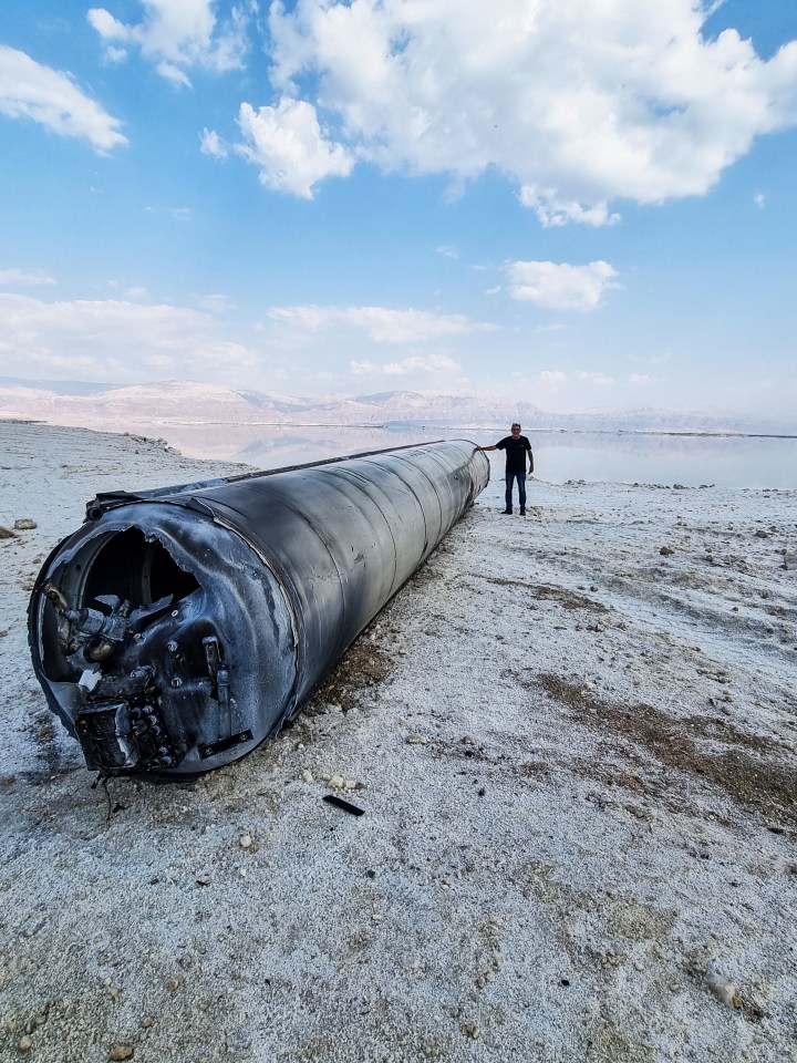 A ballistic missile lies on the shore of the Dead Sea after Iran launched a barrage on Saturday night