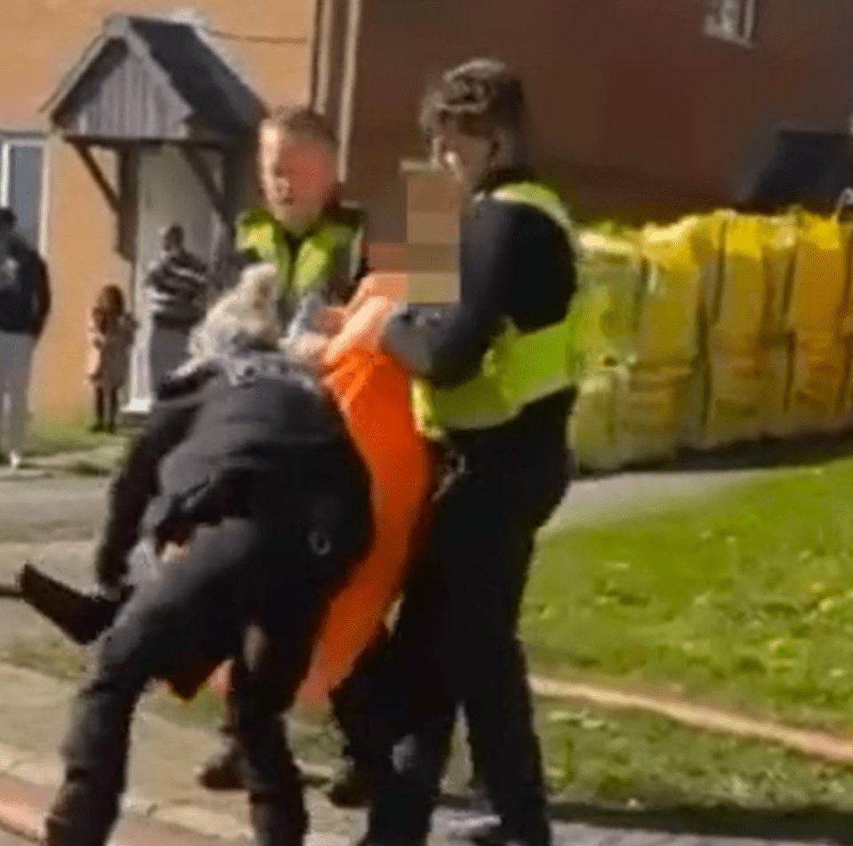 A woman was led away by police after the man’s body was discovered