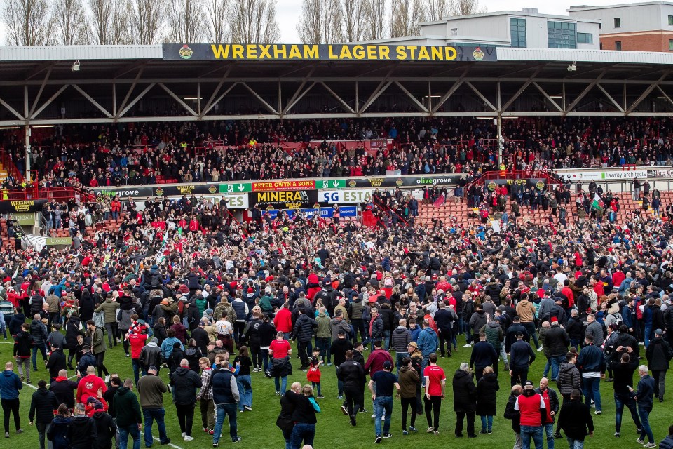 Fans invaded the pitch after promotion was sealed with a 6-0 win over Forest Green