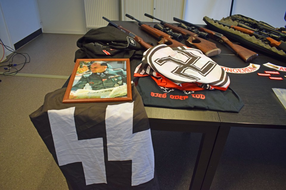 Confiscated goods, including Nazi propaganda and weapons are displayed after a raid in Hasselt, Belgium