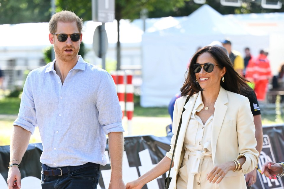 a man and a woman are holding hands while wearing sunglasses