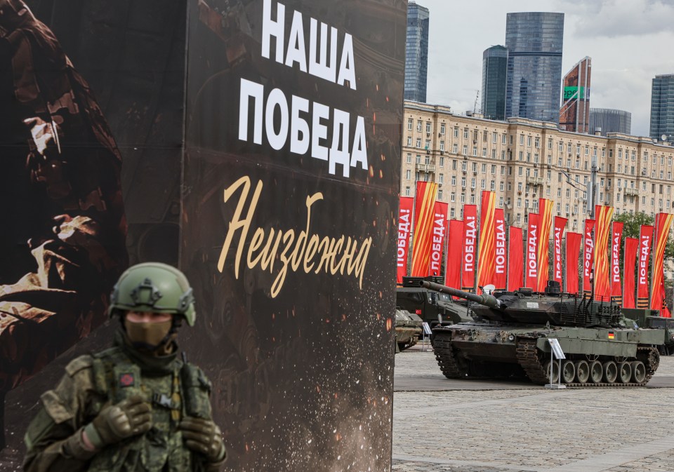 The proud banner claims 'Our victory is inevitable' with German Leopard tank in the background