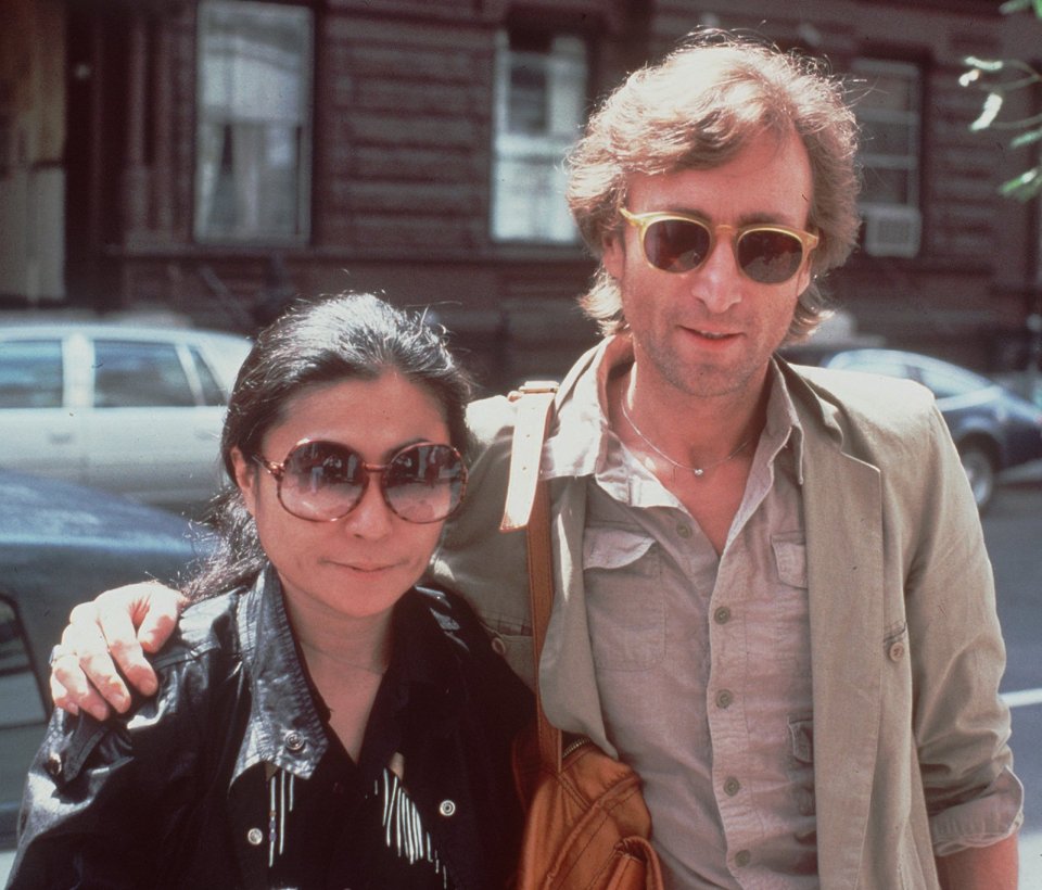 Former Beatle John Lennon and his wife, Yoko Ono, walk in the neighbourhood of their New York apartment in 1980