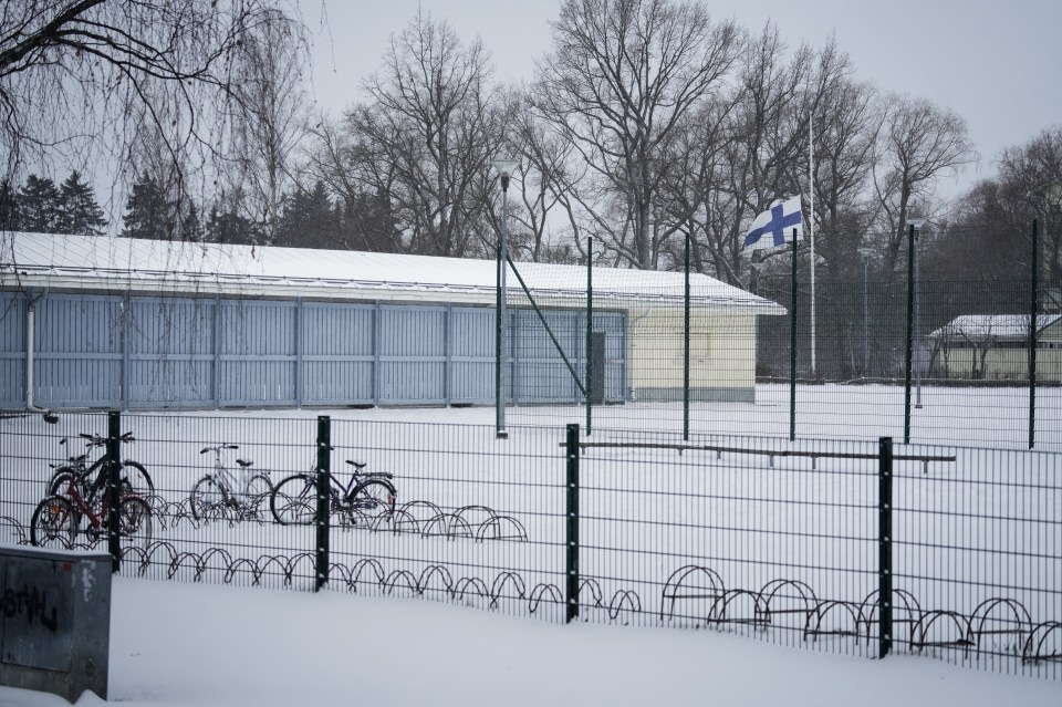 The Finish flag flies at half mast next to the schoolyard today