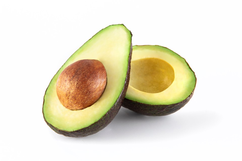 two avocados are cut in half on a white background