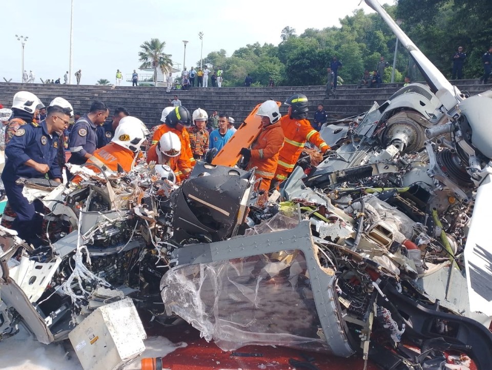 Emergency workers at the site of the wreckage of one of the downed choppers