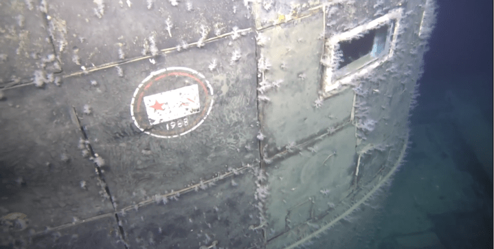 Eerie video footage shows a decaying Soviet flag and date on the nuclear sub