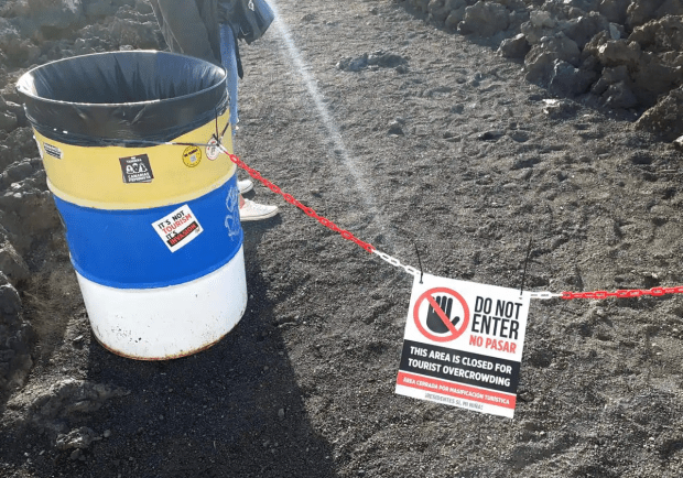 An unofficial sign in Lanzarote reads 'Do Not Enter: This area is closed for tourist overcrowding'