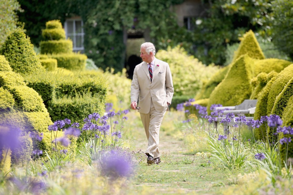 The former Prince of Wales walking through the Gardens of Highgrove House to celebrate his 70th birthday