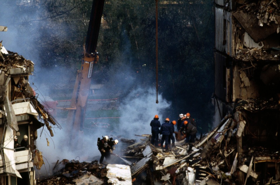 Emergency workers walk around the crash site