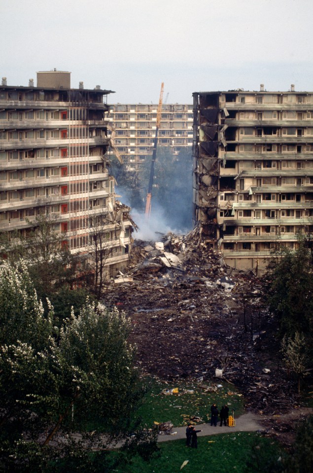 Smoke rises from the debris of the building