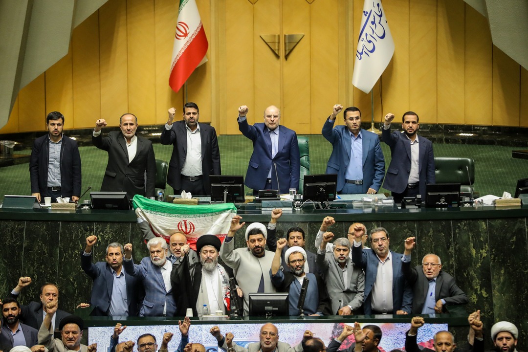 Iranian lawmakers chant during parliament session in Tehran as Iran launches dozens of drones at Israel