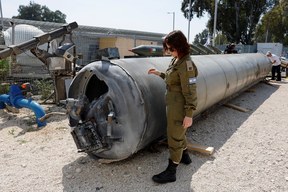 An Israeli soldier inspects a downed Iranian missile that was recovered from the Dead Sea