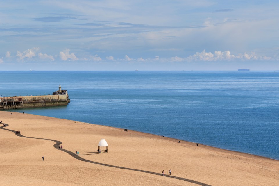 The beach is home to the Harbour Arms, bars and cafes on the former railway line