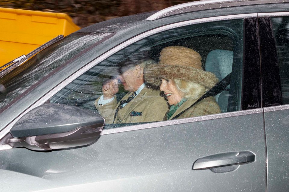 The Queen beamed in the passenger seat beside her husband