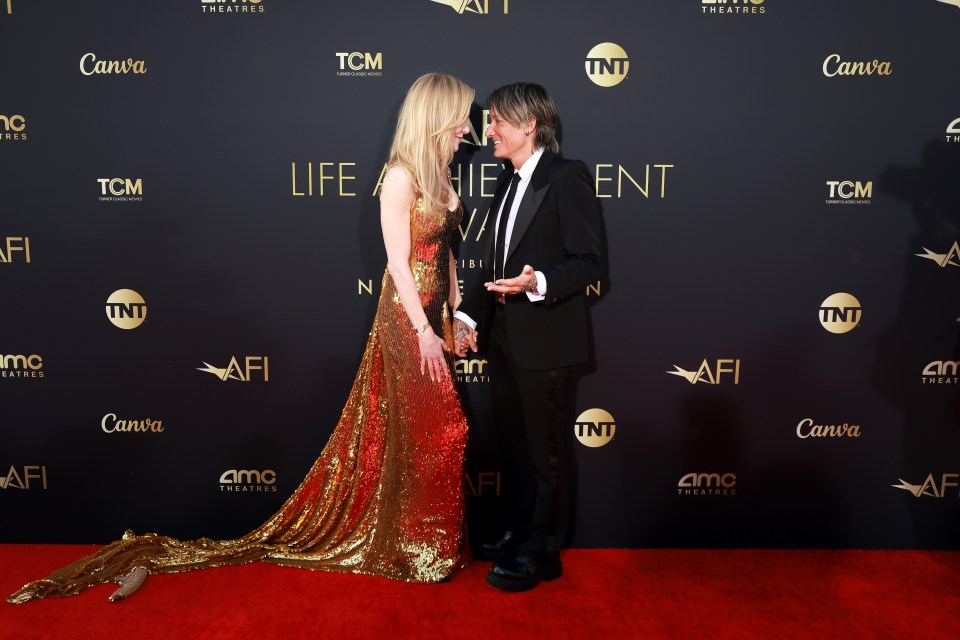 Here's Nicole Kidman enduring the bane of tall women everywhere – stooping to kiss her smaller-skeletoned husband, Keith Urban