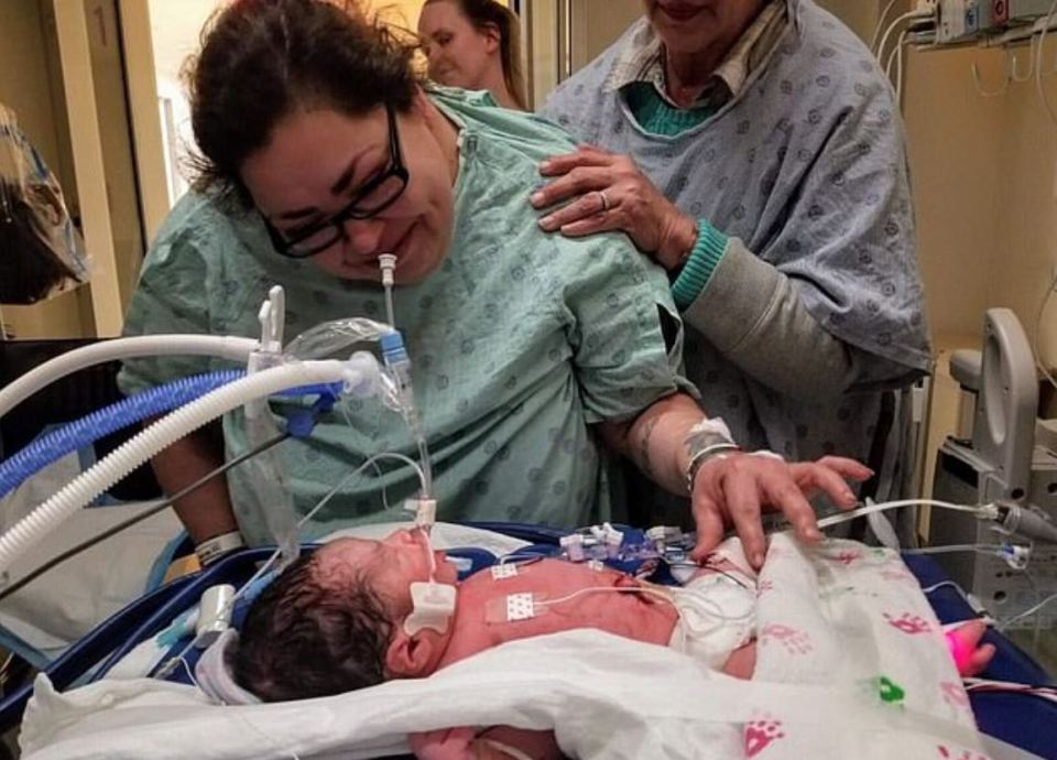 A chilling picture shows Clarisa Figueroa in hospital leaning over Marlen's gravely ill baby boy