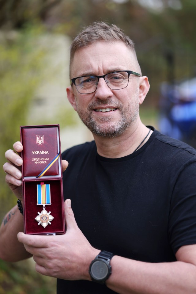 Shaun with the medal he received for fighting on the front line in Ukraine