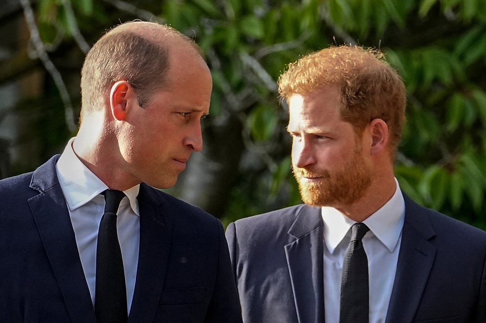 two men in suits and ties are looking at each other