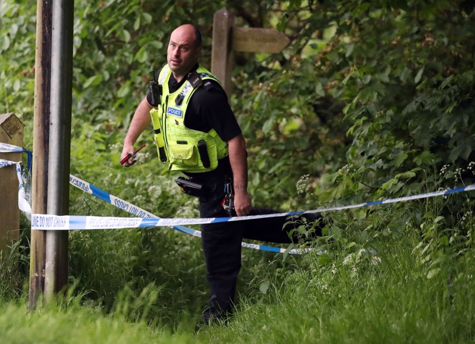 A police officer holds a hacksaw at the scene in Ovingham