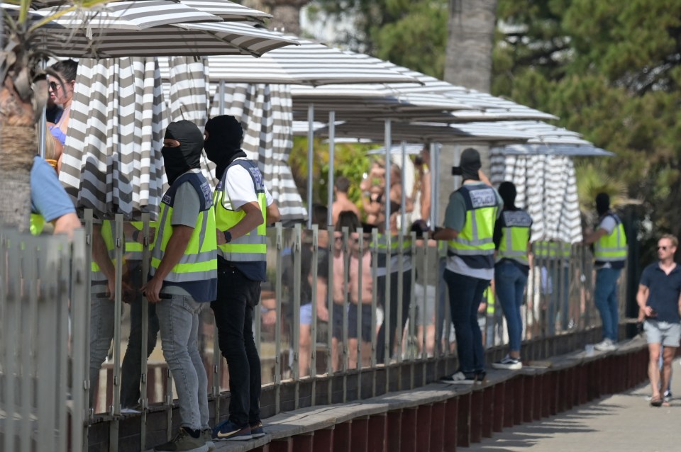 Guards stand around the perimeter of the club as the raid takes place