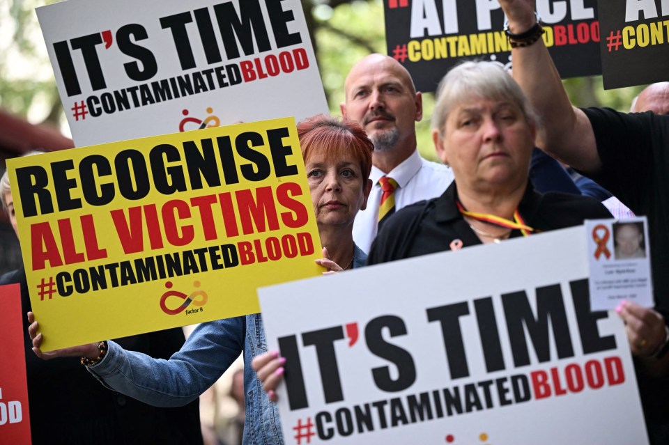 NHS infected blood scandal campaigners hold placards saying: ‘It’s time’