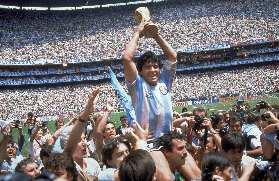 Maradona holds up his team’s trophy after Argentina’s 3-2 victory over West Germany in the final