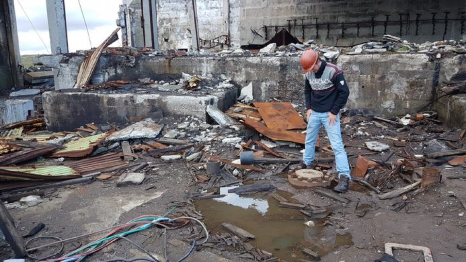 A man standing near the opening of the Kola Superdeep Borehole