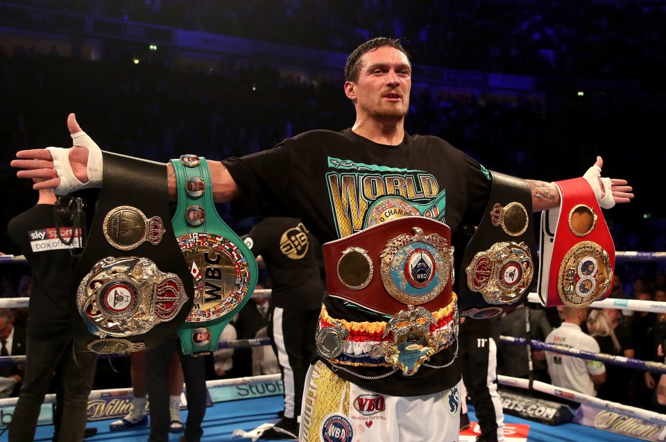 Oleksandr Usyk displays his championship boxing belts.