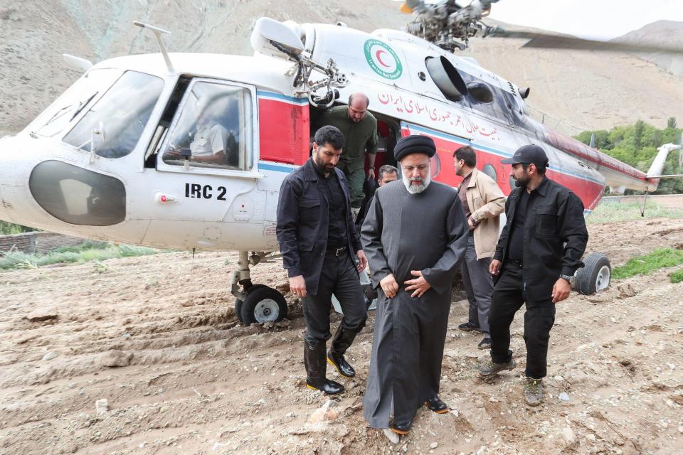 Raisi pictured with a helicopter convoy while visiting Firuzkuh after floods in July 2022