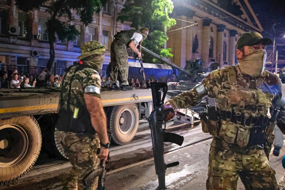 Mercenaries with Russia’s Wagner Group load a tank onto a truck in Russia’s city of Rostov-on-Don