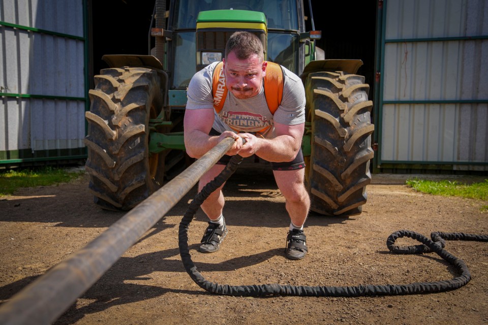 Haynes pulls a 4.2 ton tractor out from one of his barns in Oxfordshire