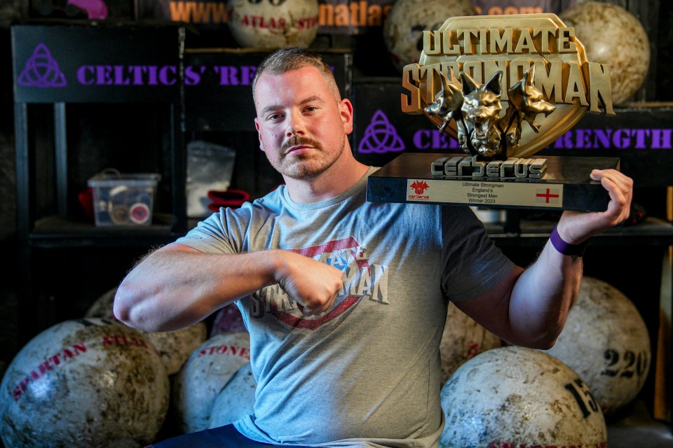 Haynes displays some of his impressive silver wear inside his farm gym